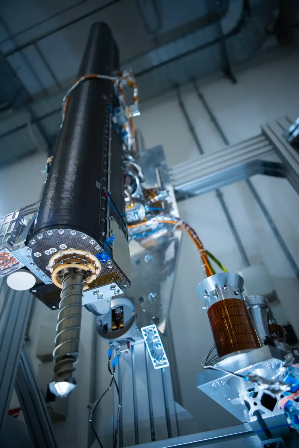 The PROSPECT robotic drill in a clean room, with its auger extended below the drill housing